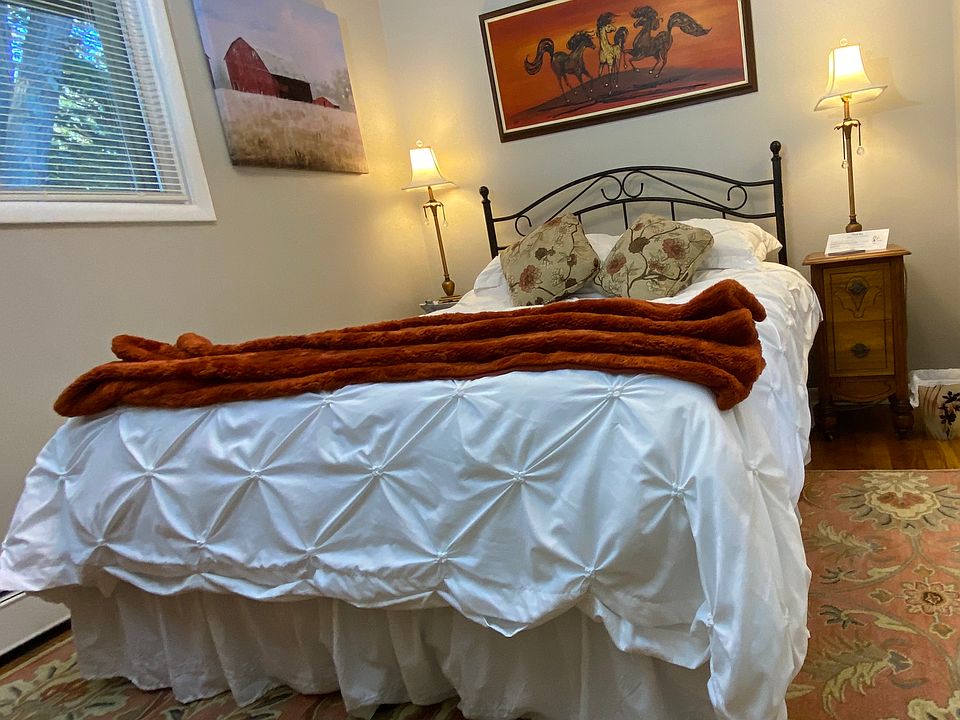 Bedroom 1, Model has a queen sized bed.