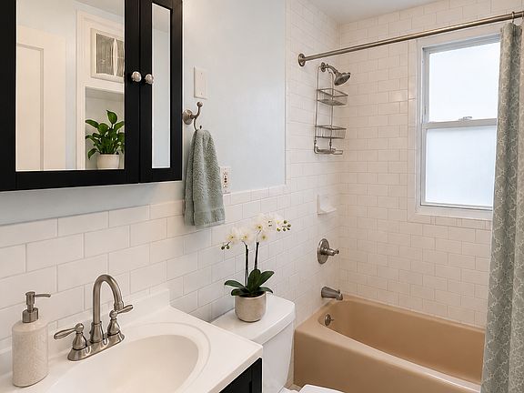 Bathroom with fan and built-in closet