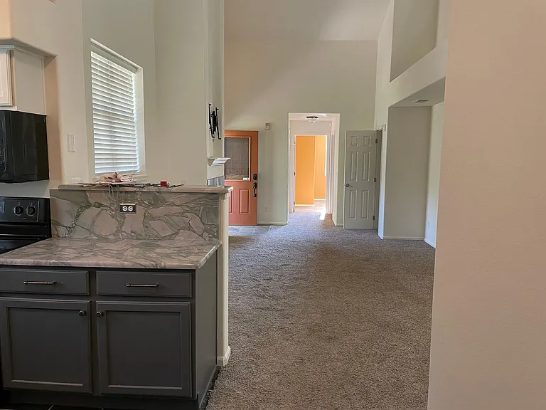 Main living area from kitchen with 2-story vaulted ceilings.