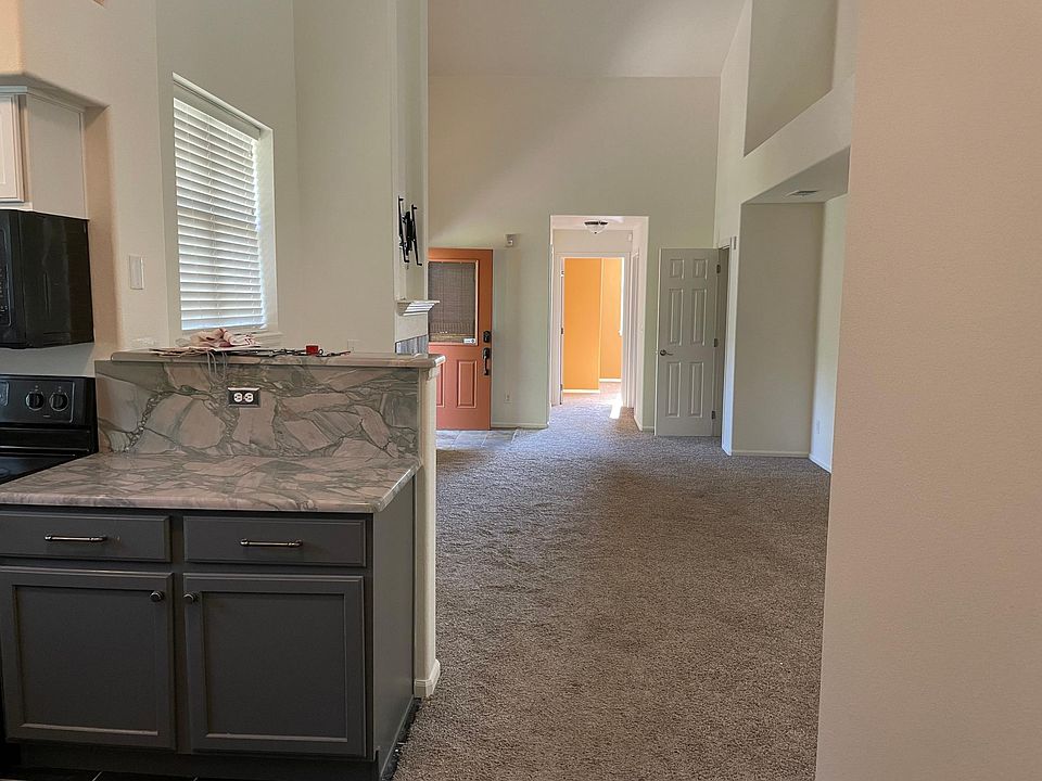 Main living area from kitchen with 2-story vaulted ceilings.