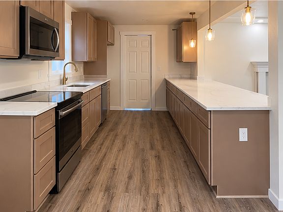 Luxurious gourmet kitchen with quartz counters and huge island