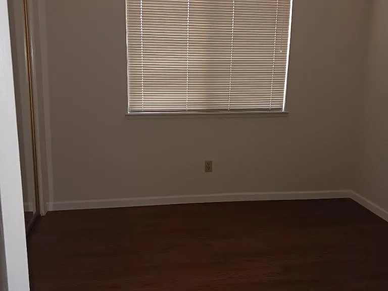 Second bedroom with closet and sliding mirror door.