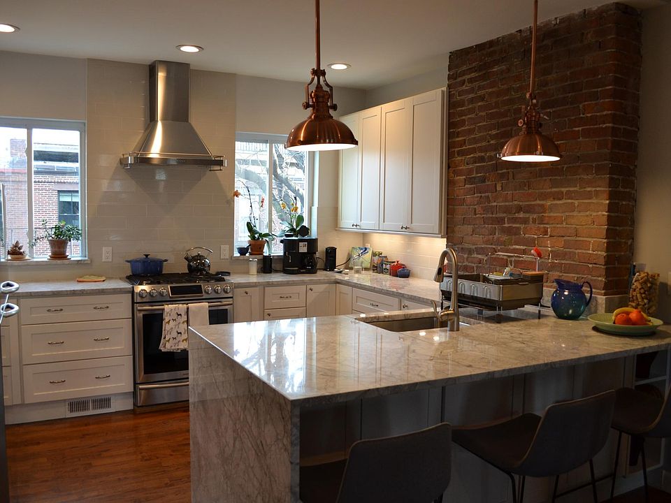 Kitchen on upper level open floor plan. Gas cooking. Dishwasher (not shown) is next to sink.