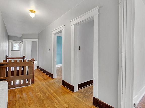 Hallway showing gated staircase going downstairs