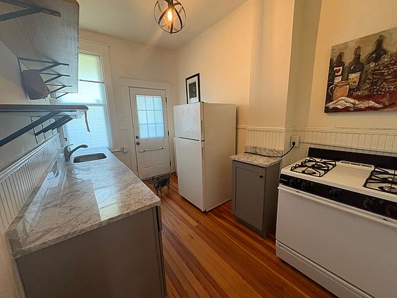 updated kitchen with gas stove and granite counters