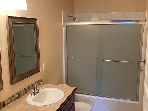 Master bath with tall, double sink and new shower doors