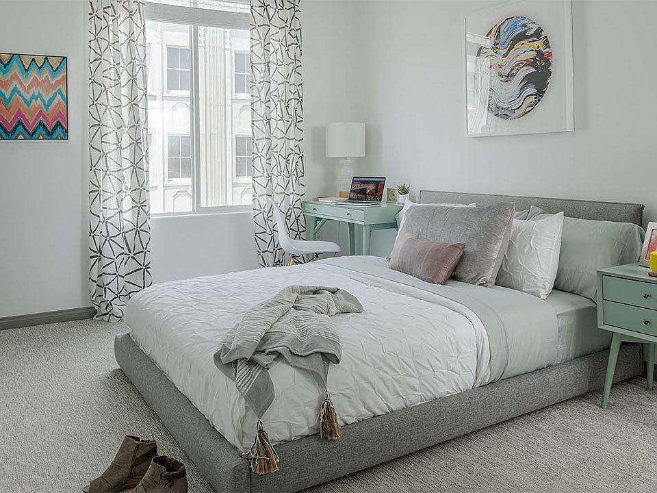 Spacious apartment bedroom with carpeted floors.