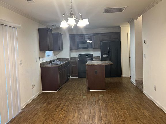Bigger view of dining area and sliding glass doors on left (vertical blinds are closed)