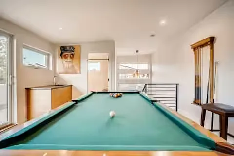 The wet bar can be seen in the left corner, as well as the doorway into the third floor full bathroom