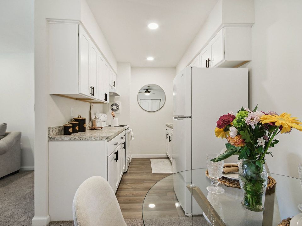 a view of beautiful white kitchen and dining room area