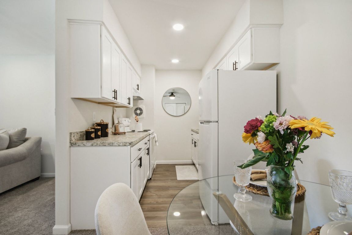 a view of beautiful white kitchen and dining room area