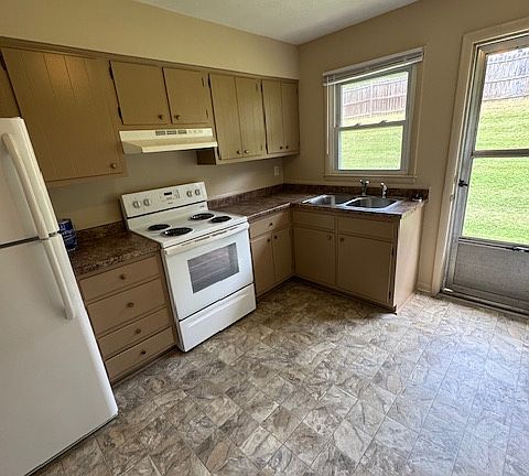 Kitchen and Dining area. White appliances with stainless steel sink