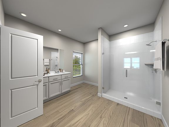 The en suite primary bath boasts dual sinks and a spacious walk in closet.