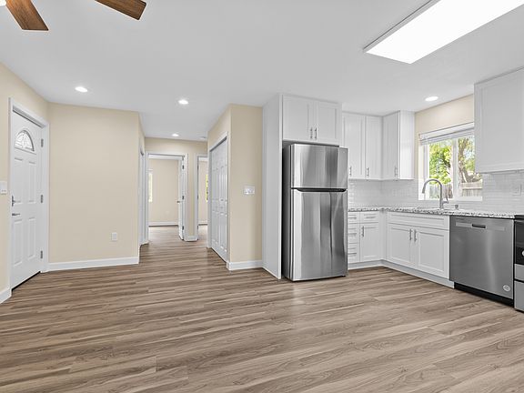 Family room with kitchen and hallway view.