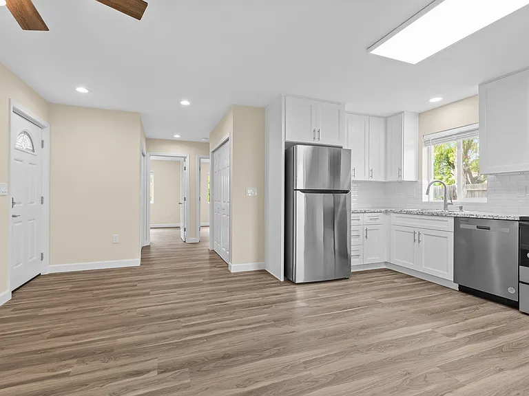 Family room with kitchen and hallway view.