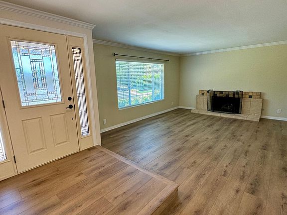 Step down living room with fireplace and recessed lighting.