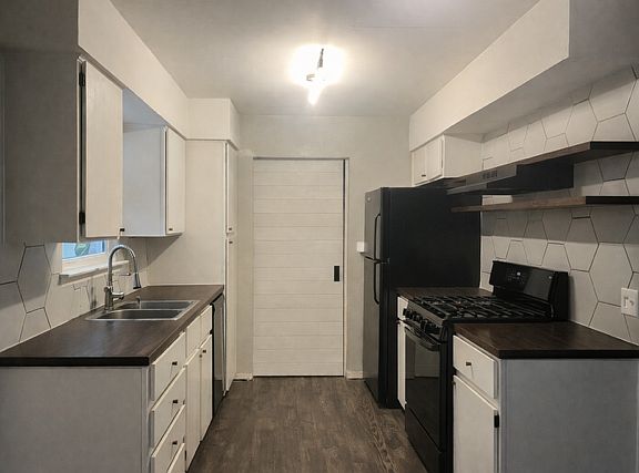 galley kitchen (sliding door leads to the laundry area, full bath with fourth bedroom/flex room)