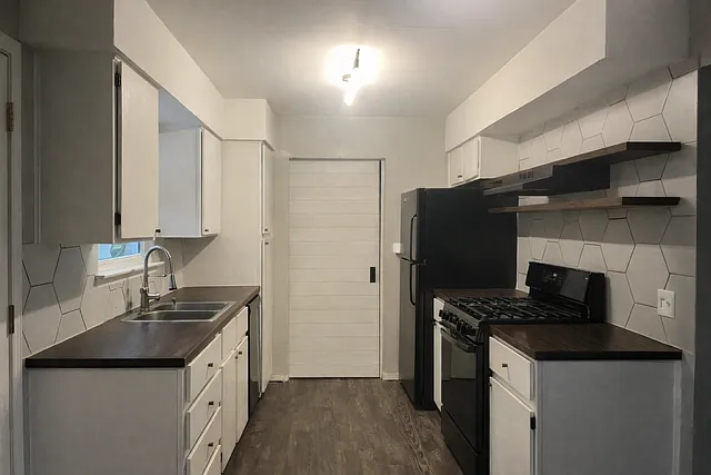 galley kitchen (sliding door leads to the laundry area, full bath with fourth bedroom/flex room)