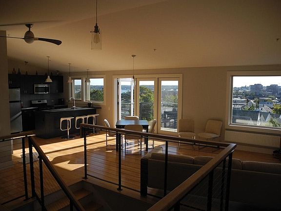 Wood, steel, cable railing around interior stairs.