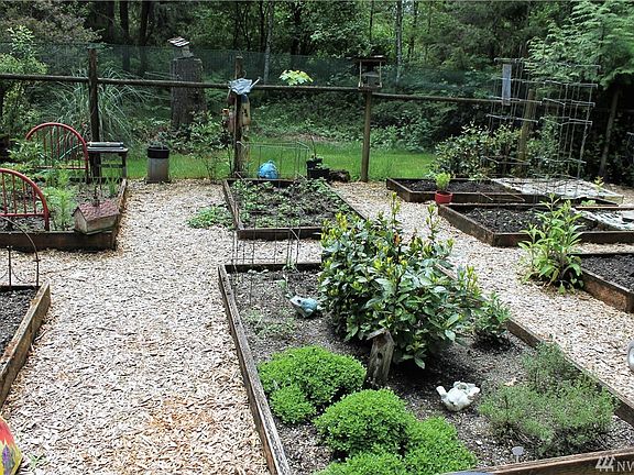Fantastic raised-bed garden space with a high fence to keep the deer out. Nearby is a useful garden shed...
