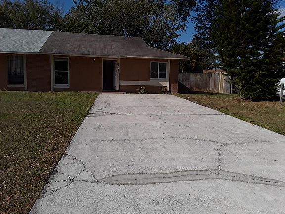 Front of home, featuring very long driveway, up to 6 cars.