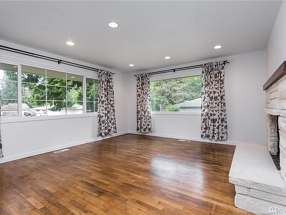 Refinished original hardwoods shine with the natural light from the large picture windows. 