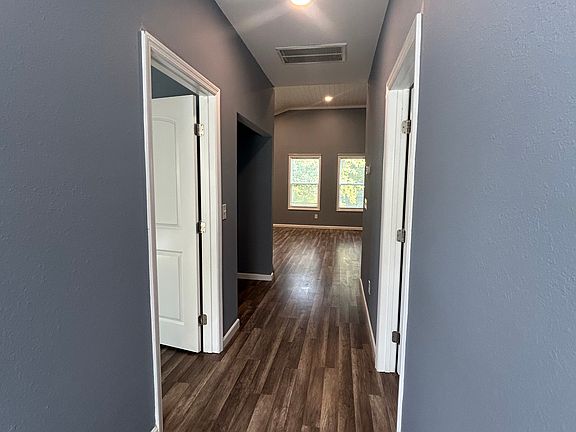 Hallway from back door to living area and front windows