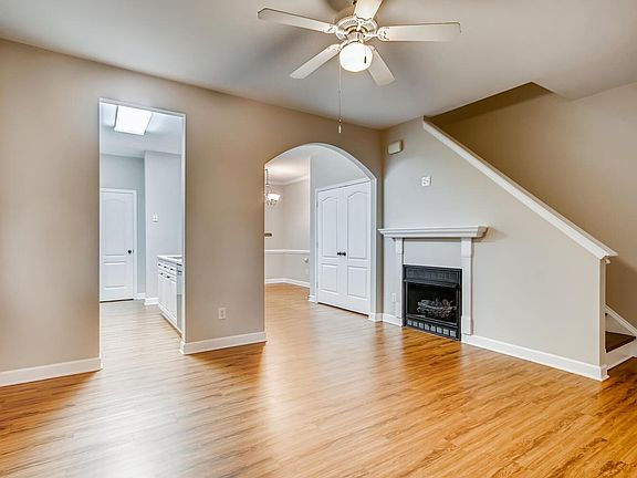 Living room has gas fireplace, ceiling fan.