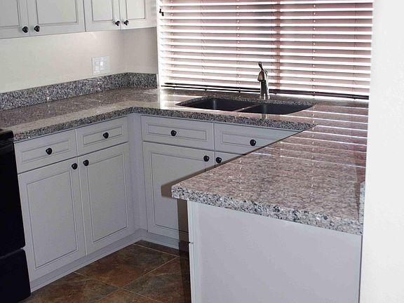Lots of granite slab counter space; undermount sink with brushed nickel fixtures