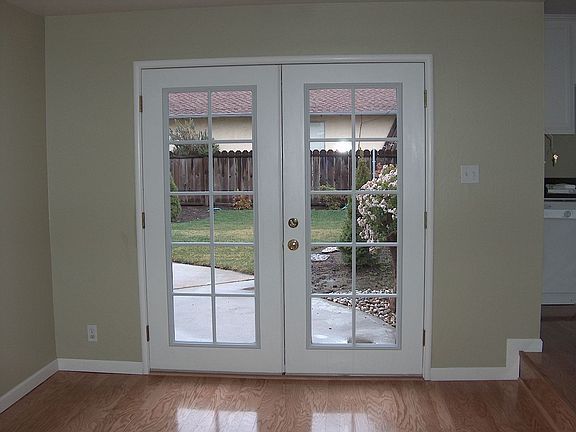Family room with double-paned French doors leading to fully-landscaped yard