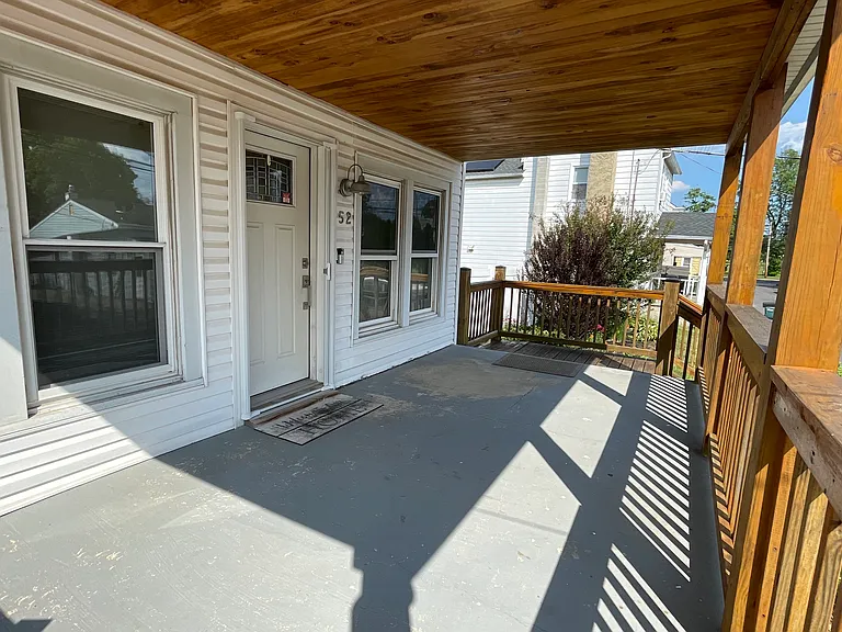 Spacious covered front porch. Perfect for relaxing, enjoying morning coffee, or unwinding at the end of the day.