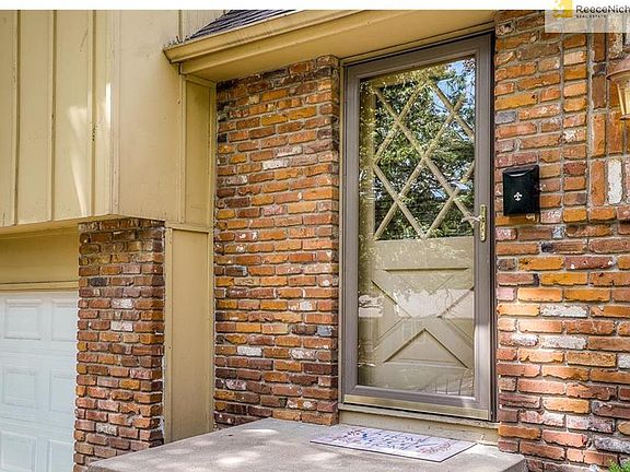 Front door with beautiful lattice work.