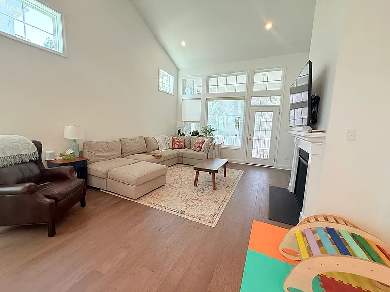 Beautiful family room with an abundance of natural lighting! French door leads out to the screened in massive deck!