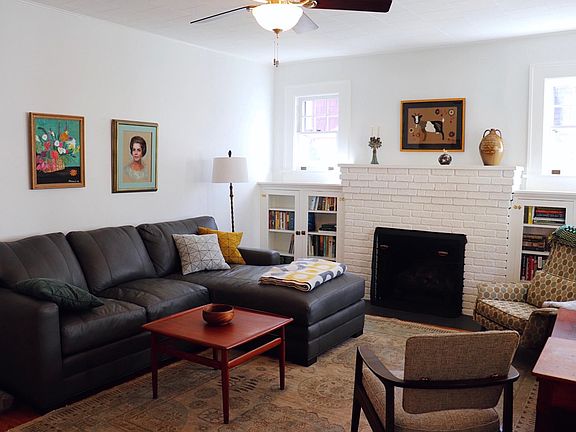 Sunny and bright living room with gas fireplace.
