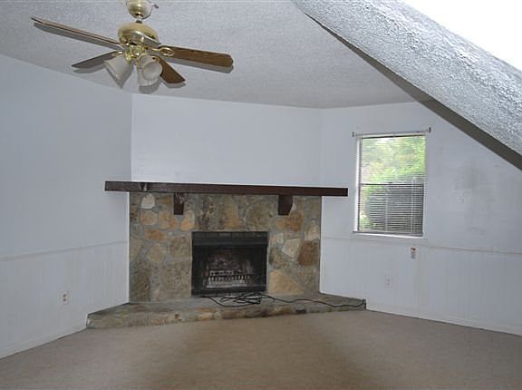 family room w/ stacked stoned fire place