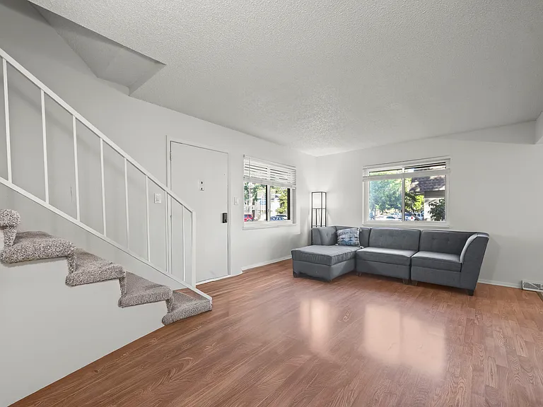 Bright and inviting living room featuring abundant natural light and an open layout ideal for everyday living and entertaining.