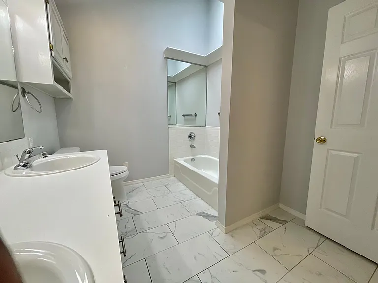 Primary bath with skylight for additional natural light.