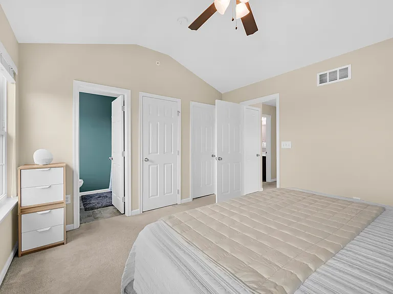 Bedroom with Vaulted Ceiling - Other doors left to right are to the private entrance en suite bathroom, linen closet, walk-in closet and hallway.