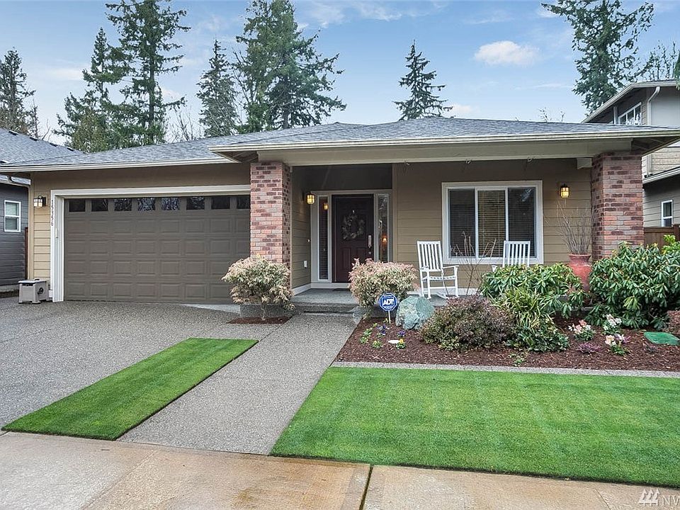 Welcome home to Woodgrove. This spacious rambler is guaranteed to impress with its luxury finishes and park-like setting. Enjoy 3 bedrooms plus a den and 2 bathrooms. Backing to a greenbelt, this home will showcase the best in Northwest living. Immaculate and open, this home is perfect for entertaining. Enjoy gleaming hardwood floors that flow throughout the main living spaces, soaring vaulted ceilings and a wall of windows overlooking the breathtaking landscape. Gather in the kitchen around the sprawling island while you enjoy all of its high-end features. Let your cares slip away in the luxurious master suite with gorgeous ensuite bath and impressive walk-in closet. 