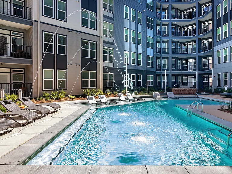 Resort Inspired Swimming Pool with Sunning Ledge and Deck Jets