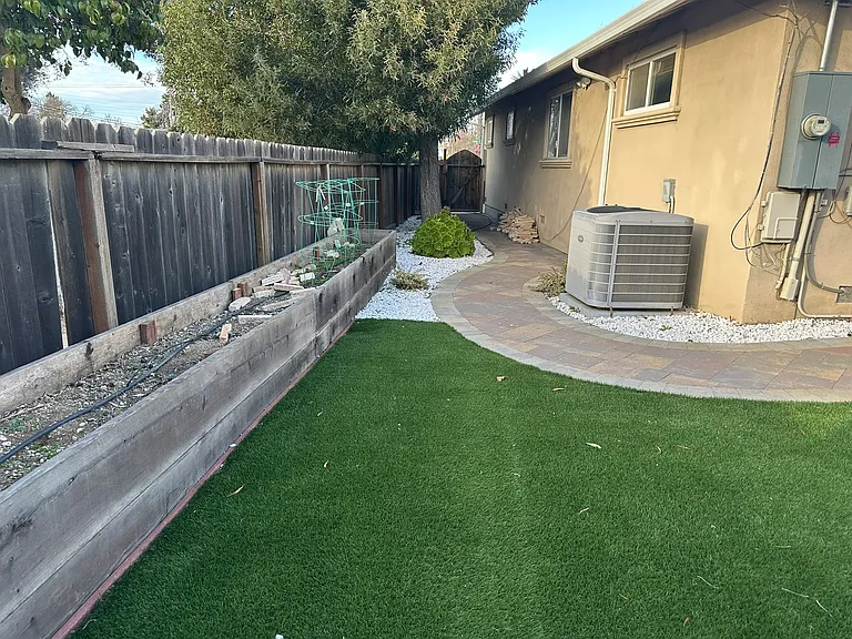 Sideyard with planters and artificial turf