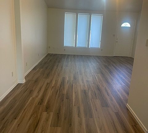 New plank flooring in living room. New window blinds.