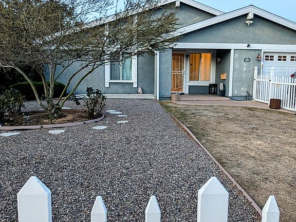 Front Home with enclosed picket fence