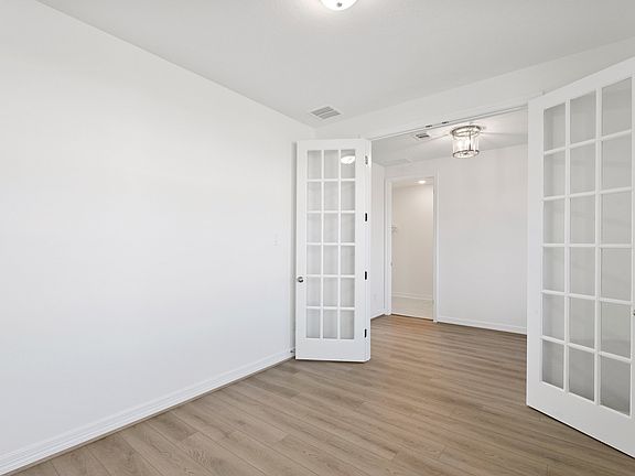 An additional view of the study featuring French doors.