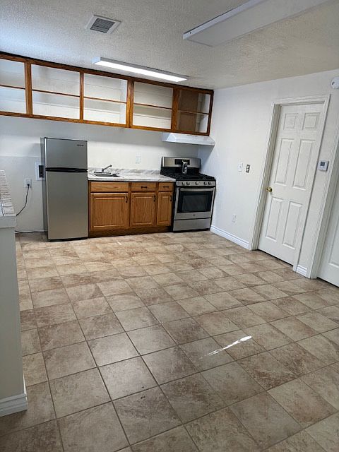 Kitchen and living area with plenty of kitchen shelving