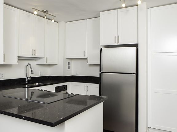 Sleek finishes include black granite countertops and custom cabinetry