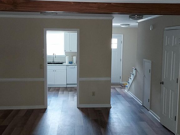 Looking forward from Living area, through Dining Area, Entry Hall and Kitchen.