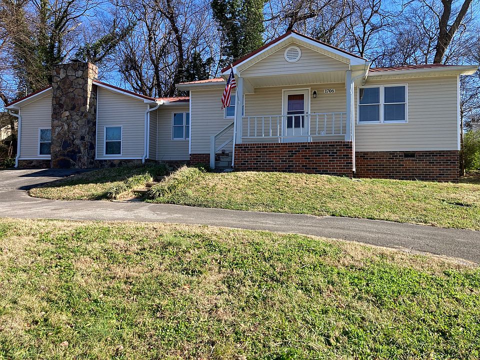 Half circle paved driveway with extra parking area