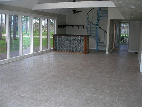 Wet Bar and spiral staircase from den and library/study area