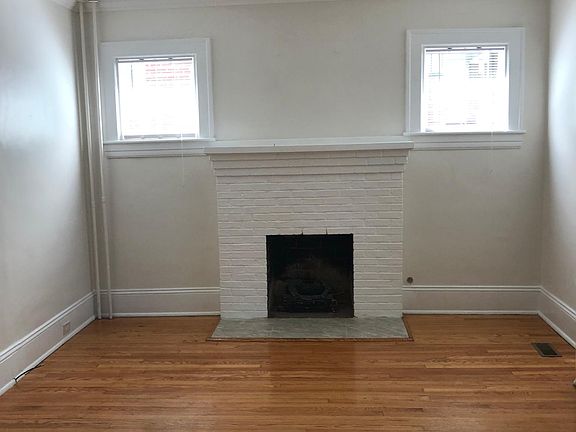 Living room off front hallway with fireplace and gas logs